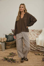 SPLIT NECK RAW EDGE LONG SLEEVE RIBBED KNIT TOP