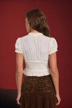 SMOCKED PEPLUM TIE NECK RUFFLED TOP