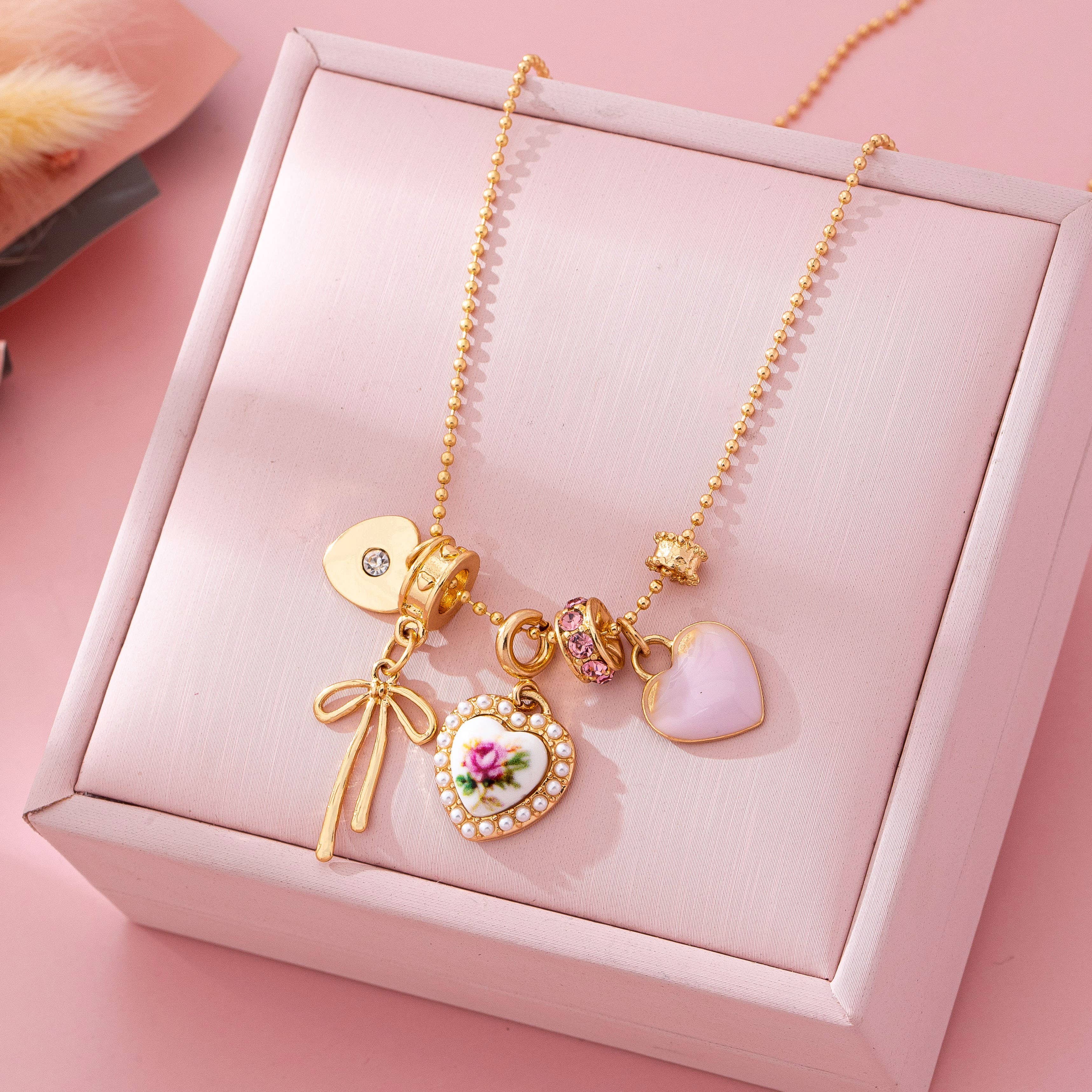 Multi Charm Porcelain Bow Ball Chain Necklace | 80N92892